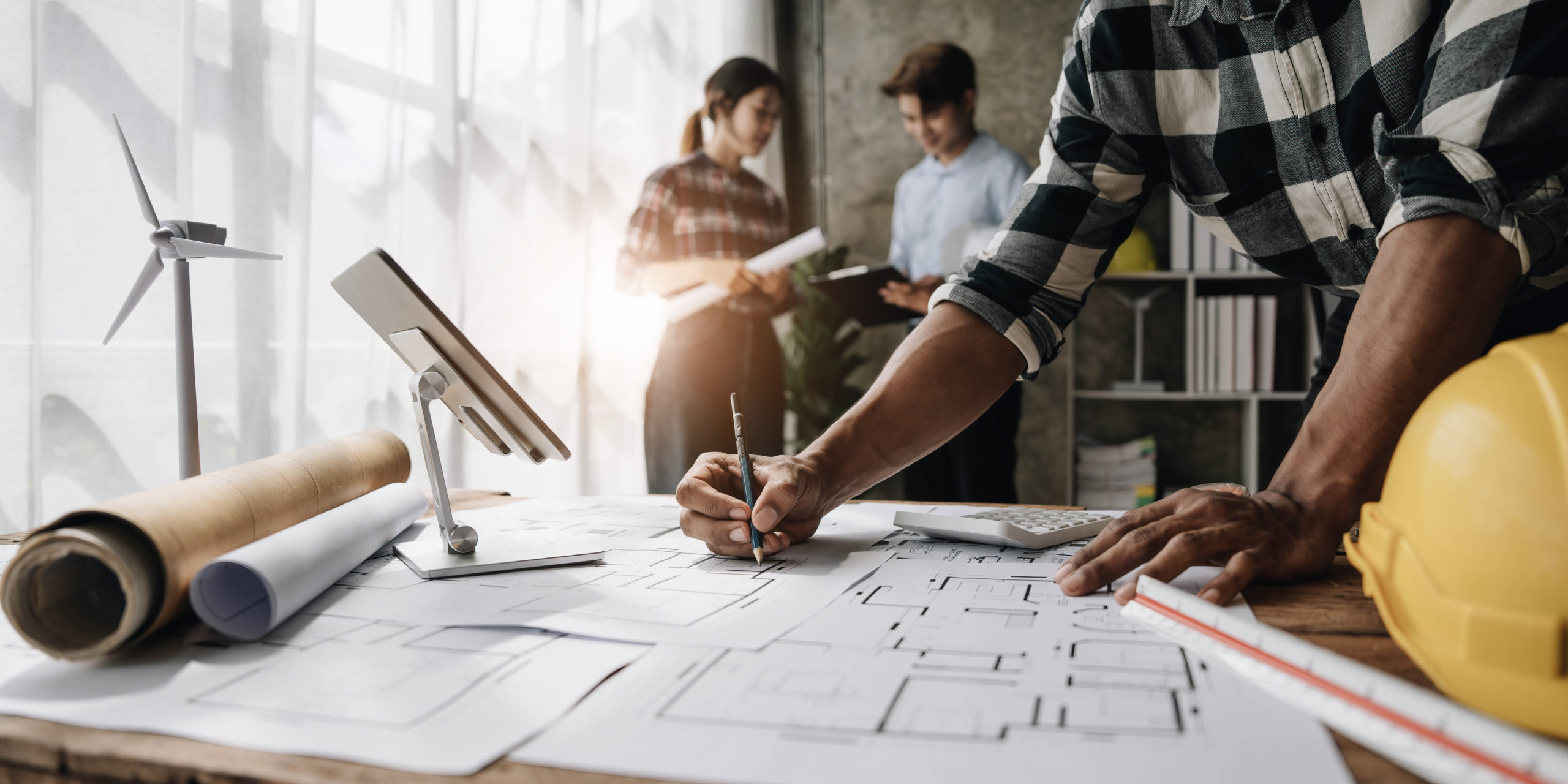 Civil engineer teams meeting working together wear worker helmets hardhat on construction site in modern city. Foreman industry project manager engineer teamwork. Asian industry professional team..